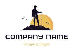 Silhouette of a hiker with a trekking pole standing on a mountain during sunrise with birds flying.